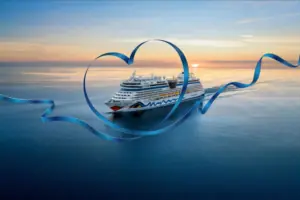 Kreuzfahrtschiff AIDAluna auf dem Meer bei Sonnenuntergang, eingerahmt von einem großen, blauen Herzband.