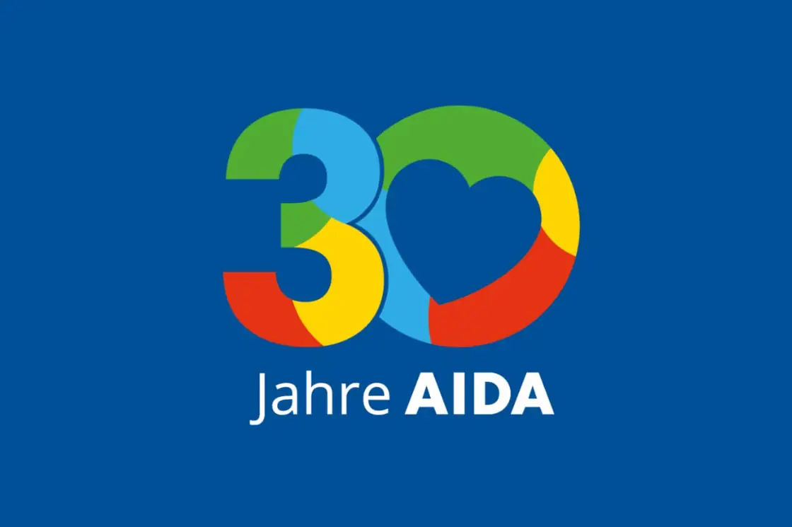 Grafik mit der Aufschrift „30 Jahre AIDA“ und einem bunten Herz auf blauem Hintergrund.